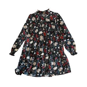 Black dress with red, cream, and green floral. Size Medium.